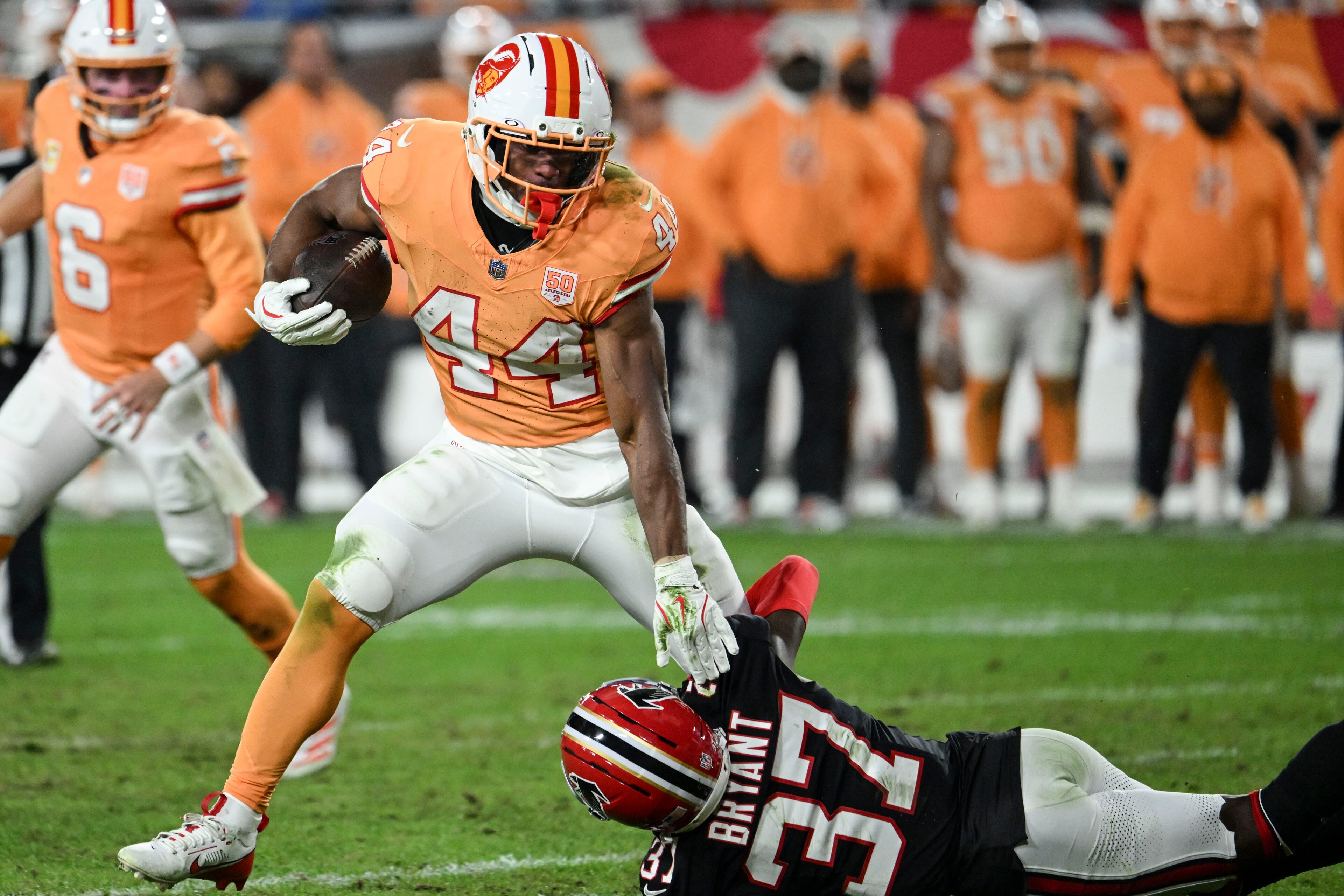 Tampa Bay Buccaneers running back Sean Tucker (44) runs against Atlanta Falcons cornerback Cobee Bryant (37) during the second half of an NFL football game, Thursday, Dec. 11, 2025, in Tampa, Fla. (AP Photo/Jason Behnken)