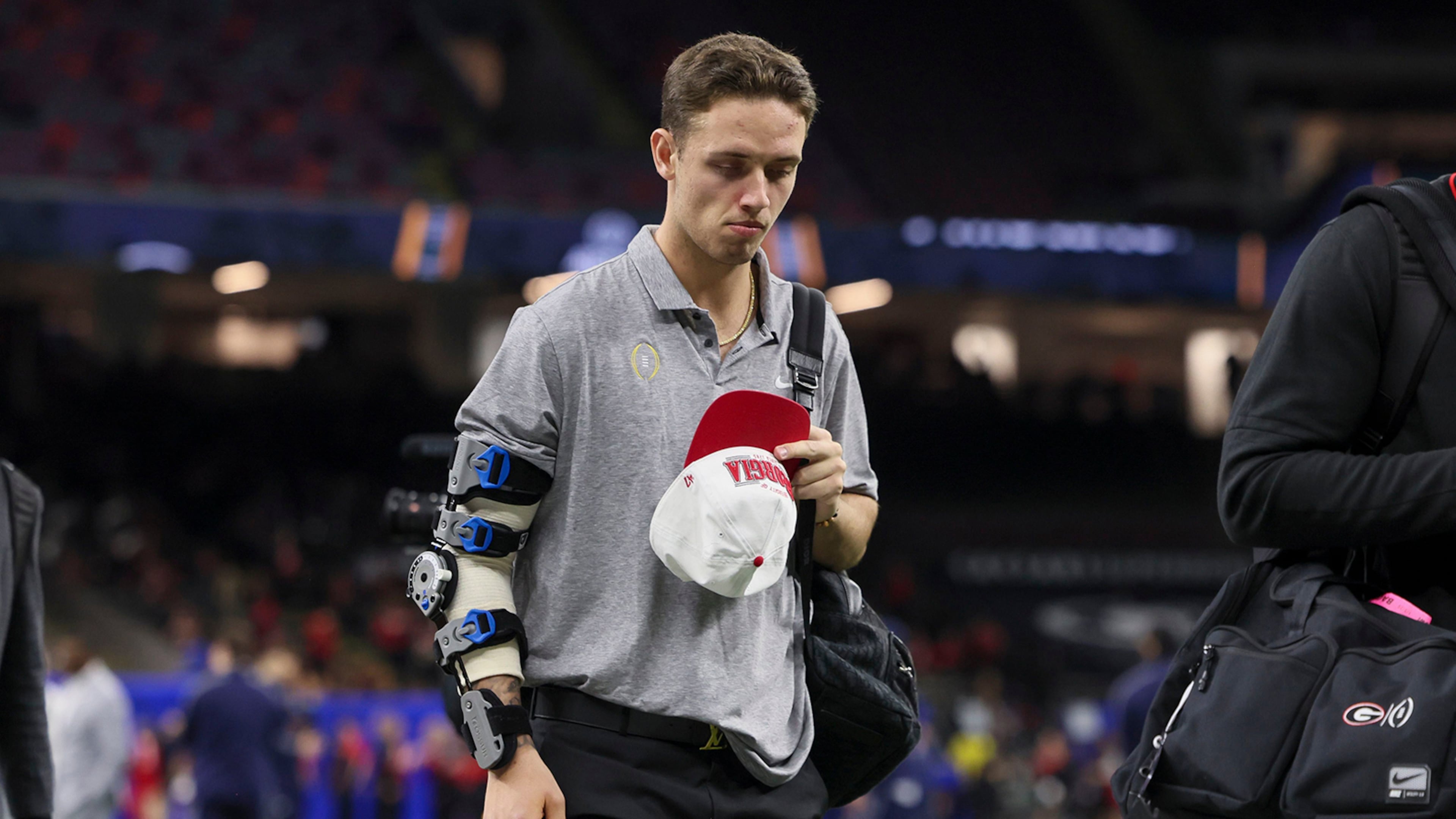 Georgia quarterback Carson Beck, his elbow injured, walks onto the field before the College Football Playoff game against Notre Dame in the Sugar Bowl at the Caesars Superdome Thursday, Jan. 2, 2025, in New Orleans. (Jason Getz/AJC/TNS)