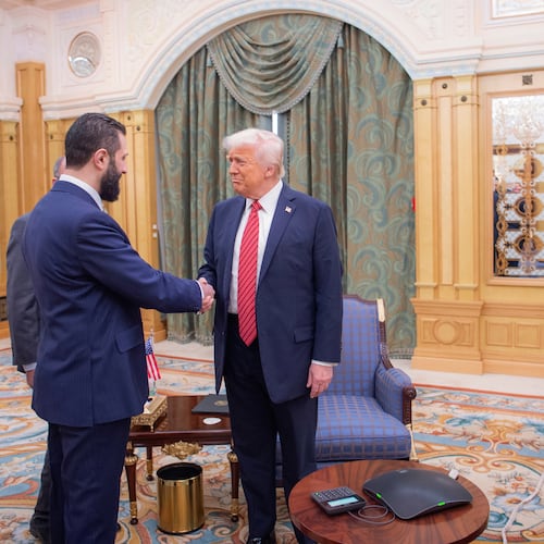FILE - In this photo provided by the Saudi Royal Palace, Syria's interim President Ahmad al-Sharaa, left, shakes hands with U.S. President Donald Trump in Riyadh, Saudi Arabia, Wednesday, May 14, 2025. At foreground right is Saudi Crown Prince Mohammed bin Salman. (Bandar Aljaloud/Saudi Royal Palace via AP, File)