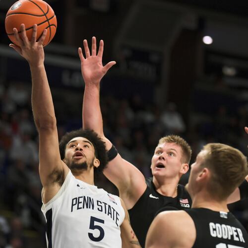 Michigan State's Jaxon Kohler, center, and Carson Cooper (15) attempt to block a shot by Penn State's Freddie Dilione V (5) during the first half of an NCAA college basketball game Saturday, Dec. 13, 2025, in State College, Pa. (AP Photo/Gary M. Baranec)
