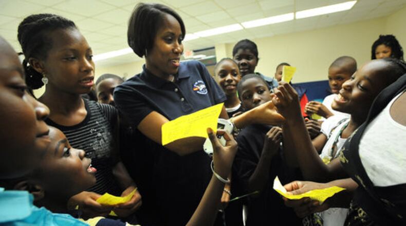 Fifth graders at C.W. Hill Elementary were excited about showing their test results to their principal Yolonda Brown as she visited their classroom on the last day of school. The school closed in 2009.  (Hyosub Shin/staff)