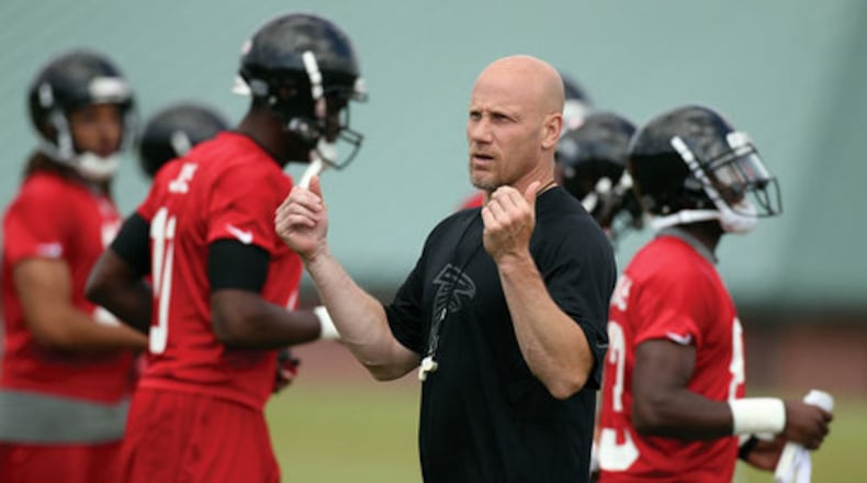 Falcons director of athletic performance Jeff Fish puts players through warm-ups. Curtis Compton, ccompton@ajc.com