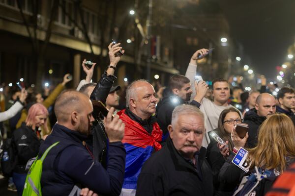 People observe 15 minutes of silence during a massive anti-government rally in Belgrade, Serbia, Saturday, March 15, 2025. (AP Photo/Marko Drobnjakovic)