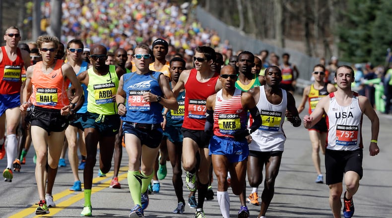 In this April 21, 2014, file photo, runners compete in the 118th Boston Marathon in Hopkinton, Mass. The 120th running of the historic footrace is scheduled for Monday, April 18, 2016. (AP Photo/Steven Senne, File)