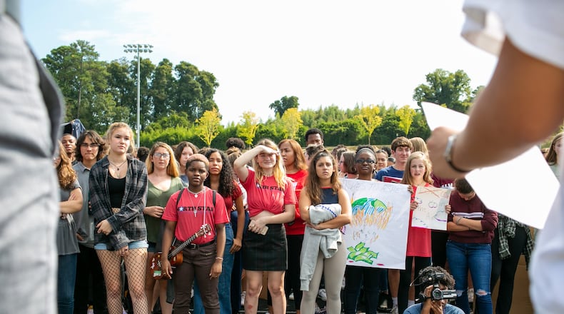 North Atlanta High School students listen to Emily D’Achiardi, senior at North Atlanta High School and Student Government president, during a school-wide climate walkout on Thursday, Sept. 26, 2019, in Atlanta, Georgia. Students walked out to call for action against climate change. REBECCA WRIGHT FOR THE ATLANTA JOURNAL CONSTITUTION