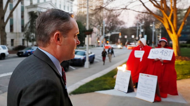 State Rep. Ed Setzler, R-Acworth, author of the anti-abortion “heartbeat” bill, walked past protestors on Monday as he arrived for the Senate committee meeting at which HB 481 was voted out. Bob Andres, bandres@ajc.com