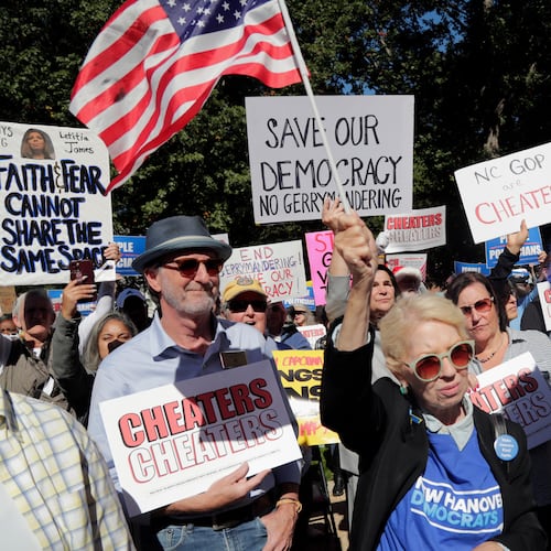 Attendees cheer during a rally protesting a proposed redistricting map Tuesday, Oct. 21, 2025, in Raleigh, N.C. (AP Photo/Chris Seward)