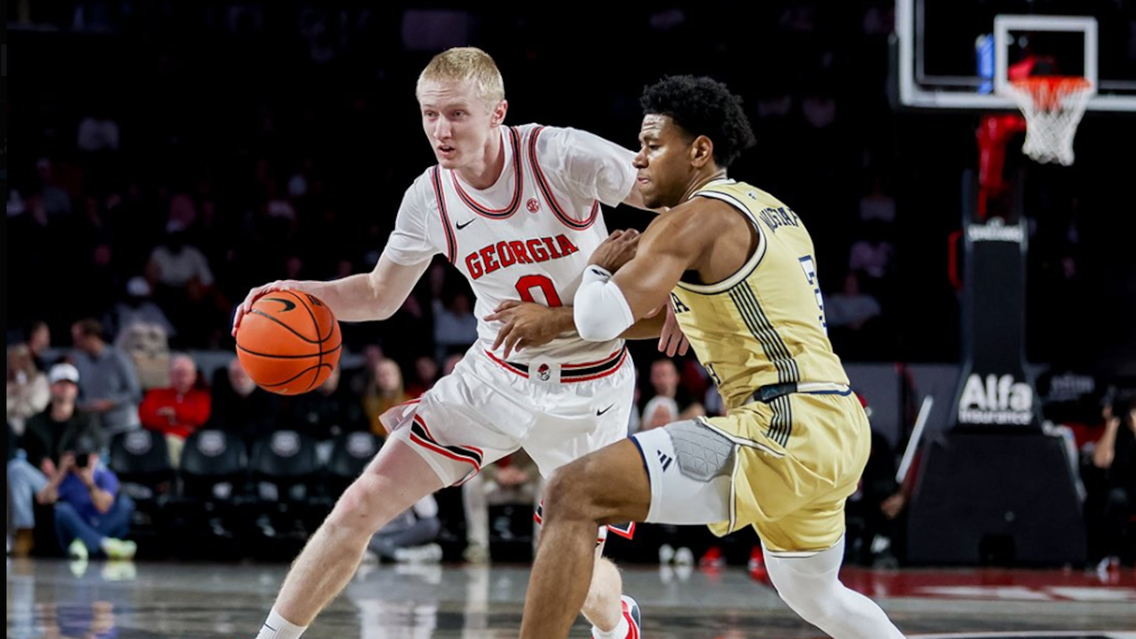Georgia's Blue Cain is defended by Georgia Tech's Jaeden Mustaf in the teams' Friday night game at Stegeman Coliseum.