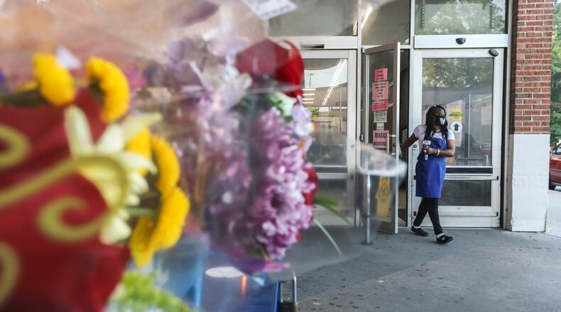 Ex-Big Bear Supermarket employee Dora Crawford leaves the store Tuesday after grieving with former coworkers.