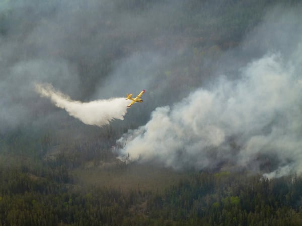 A water bomber aircraft battles a wildfire in southeast Manitoba as shown in this handout photo provided by the Manitoba government on Tuesday, May 27, 2025. (Manitoba government via The Canadian Press via AP)