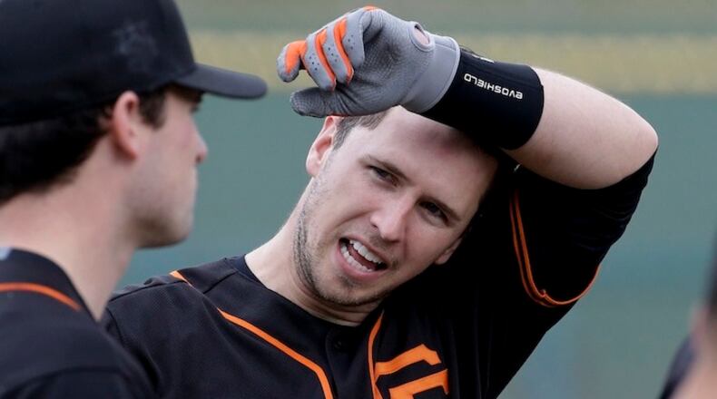 San Francisco Giants catcher Buster Posey talks during batting practice during the spring baseball season in Scottsdale, Ariz., Thursday, Feb. 18, 2016. (AP Photo/Chris Carlson)