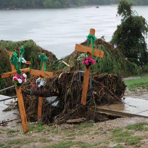 FILE - Rain falls as Irene Valdez visits a make-shift memorial for flood victims along the Guadalupe River, Sunday, July 13, 2025, in Kerrville, Texas. (AP Photo/Eric Gay, File)