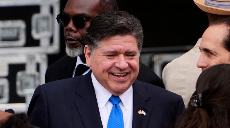 FILE - Illinois Gov. JB Pritzker, center, mingles ahead of the Obama Presidential Center dedication ceremony Thursday, June 18, 2026, in Chicago. (AP Photo/Jeff Roberson,File)