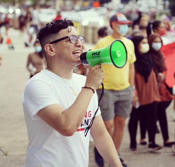 Sikandar Husseini during an August demonstration in support of Afghan citizens. Husseini was in middle school when the attacks took place, and has since used his voice to support Afghans and Muslims in his community.