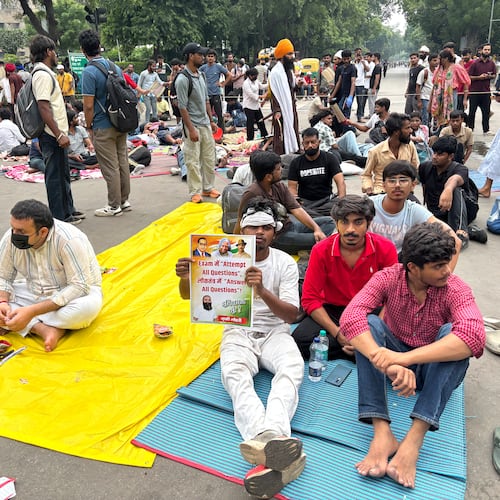 A protestor carries a placard saying "In the exam attempt all questions, in a democracy answer all questions" during a demonstration demanding educational reforms as part of the Cockroach Janta Party's ongoing protest movement in New Delhi, India, Friday, July 24, 2026. (AP Photo/Shonal Ganguly)