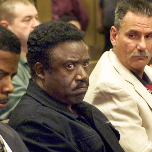 Former DeKalb County sheriff Sidney Dorsey is surrounded by heavy guard after his arrest. He was later convicted of murder in the death of former sheriff-elect Derwin Brown. (AJC file)