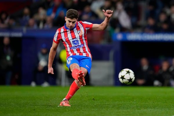 FILE - Atletico Madrid's Julian Alvarez shoots to score the opening goal during the Champions League opening phase soccer match between Atletico Madrid and Slovan Bratislava at Riyadh Air Metropolitano stadium in Madrid, Spain, Wednesday, Dec. 11, 2024. (AP Photo/Manu Fernandez, File)