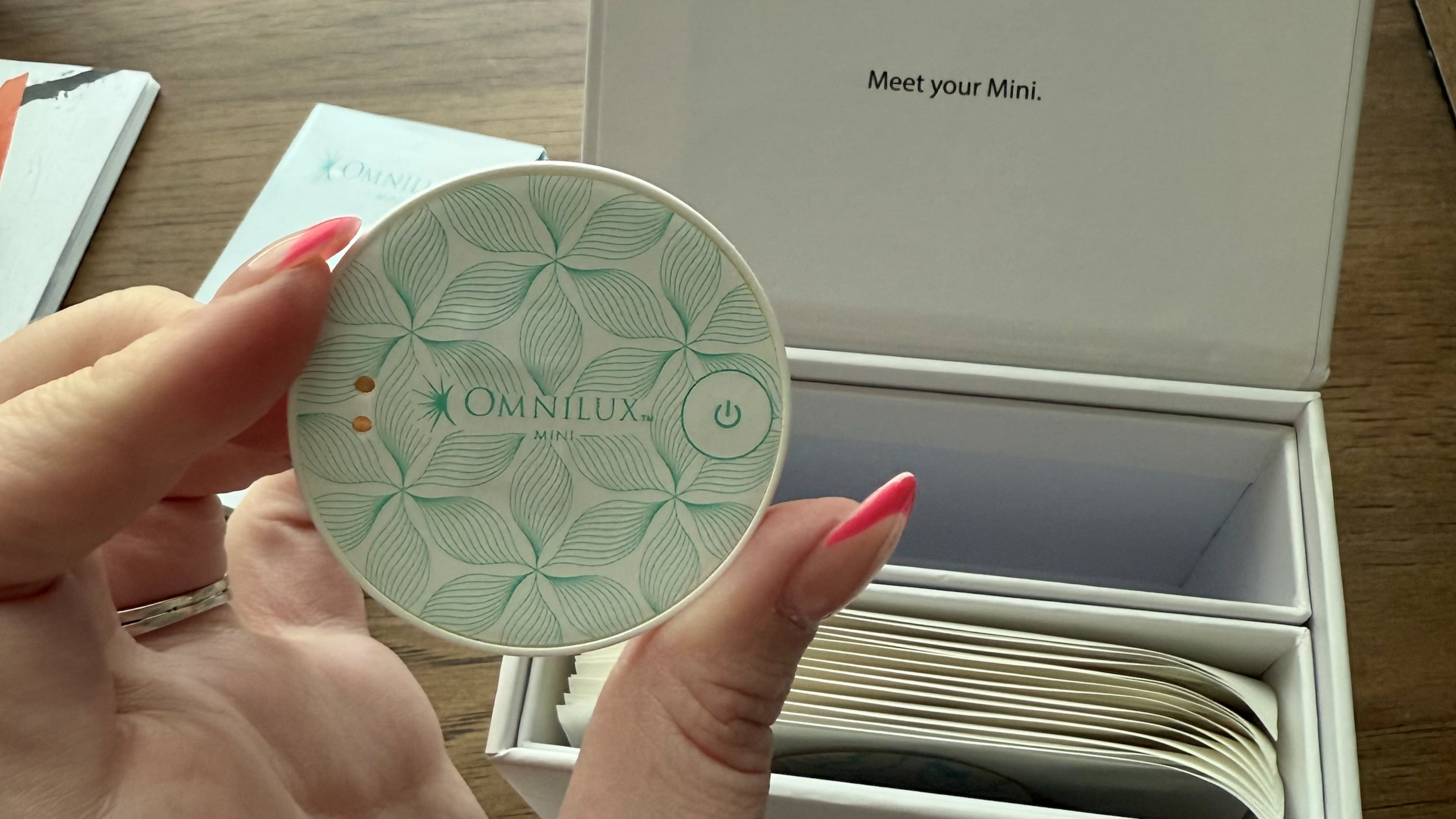 The Omnilux Mini Skin Corrector uses red light therapy to target redness, dark spots and fine lines — all in a device that fits in the palm of your hand. (Avery Newmark/AJC)