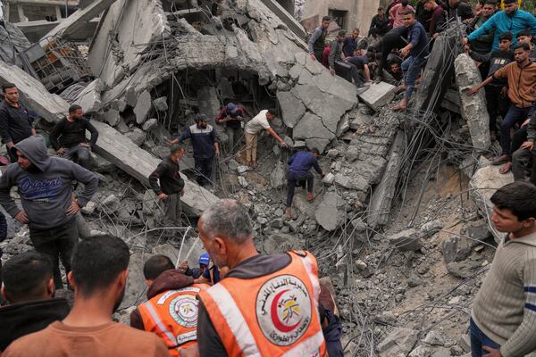 Volunteers and emergency workers search for bodies or survivors from the rubble of the Manoun family's house after it was targeted by an Israeli army strike in Jabalia al-Balad, Gaza City, Sunday, April 13, 2025. (AP Photo/Jehad Alshrafi)