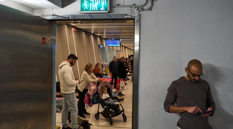 People take shelter in an underground metro station as air raid sirens warn of incoming Iranian missile strike, in Ramat Gan, Israel, Tuesday, March 10, 2026. (AP Photo/Oded Balilty)