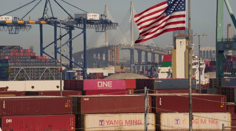 FILE - Containers with Yang Ming Marine Transport Corporation, a Taiwanese container shipping company, are stacked up at the Port of Los Angeles with the the Long Beach International Gateway Bridge seen in the background on Wednesday, April 9, 2025 in Los Angeles. (AP Photo/Damian Dovarganes, File)