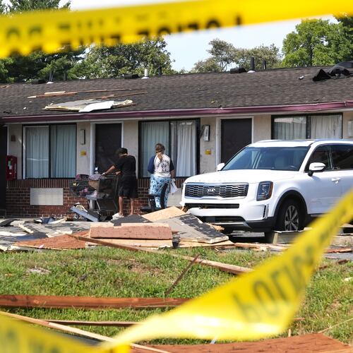 Hotel residents return to the tornado-damaged Days Inn by Wyndham Dover Downtown hotel after picking up food and supplies Friday, Aug. 21, 2026, in Dover, Del. (AP Photo/Mingson Lau)