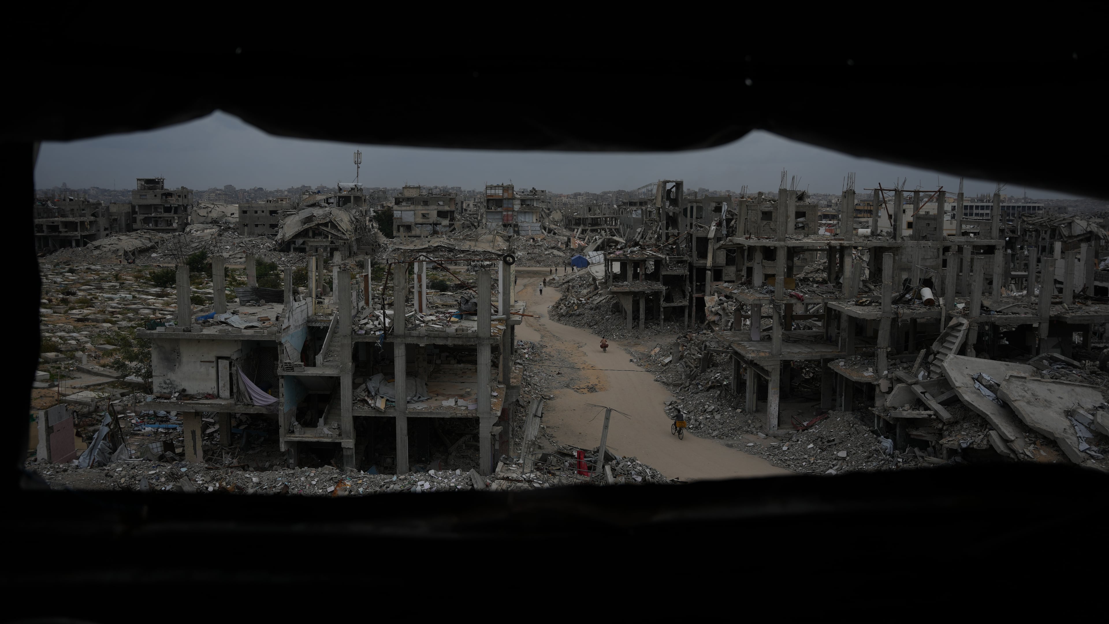 Palestinians walk through the destruction left by the Israeli air and ground offensive in Jabaliya, northern Gaza Strip, Saturday, Dec. 6, 2025. (AP Photo/Abdel Kareem Hana)