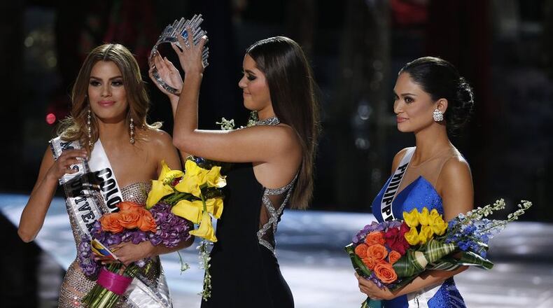 Former Miss Universe Paulina Vega, center, removes the crown from Miss Colombia Ariadna Gutierrez, left, before giving it to Miss Philippines Pia Alonzo Wurtzbach, right, at the Miss Universe pageant on Sunday, Dec. 20, 2015, in Las Vegas. Gutierrez was incorrectly named the winner before Wurtzbach was given the Miss Universe crown. AP Photo/John Locher