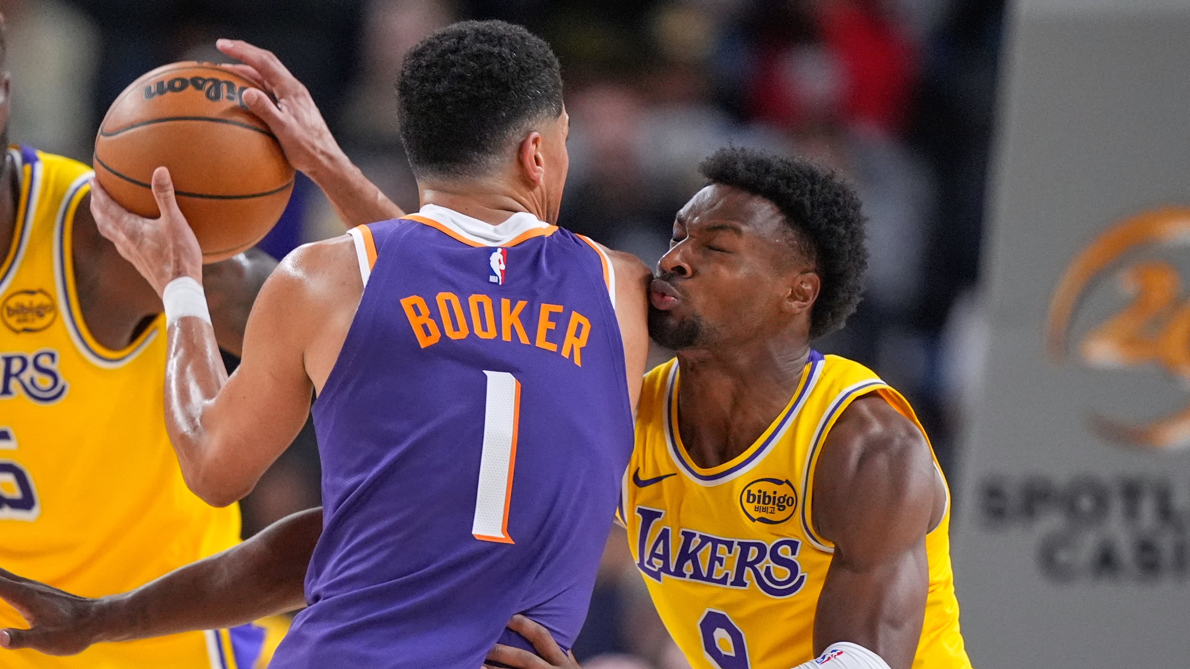 Phoenix Suns guard Devin Booker, left, tries to get by Los Angeles Lakers guard Bronny James during the first half of an NBA preseason basketball game Friday, Oct. 3, 2025, in Palm Desert, Calif. (AP Photo/Mark J. Terrill)