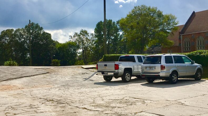 The east side parking lot at Thankful Baptist Church, which is in the background. Decatur’s commission has approved a small mixed-use project that would cover 1.15 acres of this lot. Bill Banks file photo for the AJC