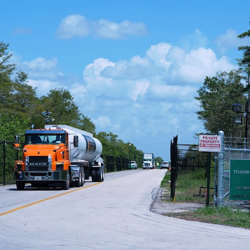 FILE - Trucks come and go from the "Alligator Alcatraz" immigration detention center in the Florida Everglades, Thursday, Aug. 28, 2025, in Collier County, Fla. (AP Photo/Rebecca Blackwell, File)