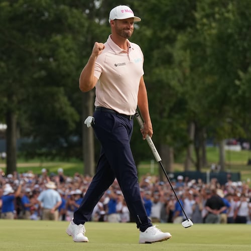 Wyndham Clark celebrates winning on the 18th green in the final round of the BMW Championship golf tournament, Sunday, Aug. 23, 2026, in St. Louis. (AP Photo/Jeff Roberson)