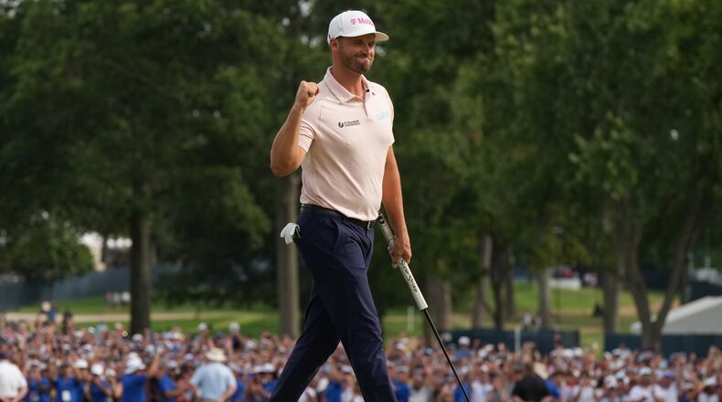 Wyndham Clark celebrates winning on the 18th green in the final round of the BMW Championship golf tournament, Sunday, Aug. 23, 2026, in St. Louis. (AP Photo/Jeff Roberson)