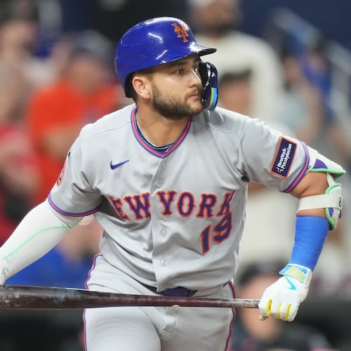 New York Mets' Bo Bichette watches as he flies out to center field during the ninth inning of a baseball game against the Miami Marlins, Friday, May 22, 2026, in Miami. (AP Photo/Lynne Sladky)