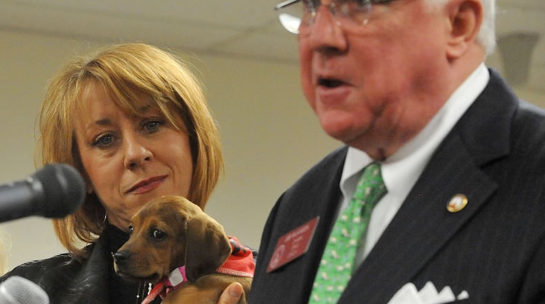 Tara High, vice president of the Atlanta Humane, holds Buttercup next to state Rep. Joe Wilkinson, R-Atlanta, at a 2015 press conference introducing legislationon the “official state dog” of Georgia. Kent D. Johnson, kdjohnson@ajc.com