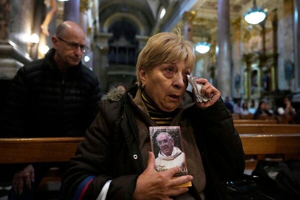 A faithful holds a portrait of the late Pope Francis during Mass at the Basílica de San José de Flores, where he worshipped as a youth, following the Vatican's announcement of his death in Buenos Aires, Argentina, Monday, April 21, 2025. (AP Photo/Gustavo Garello)