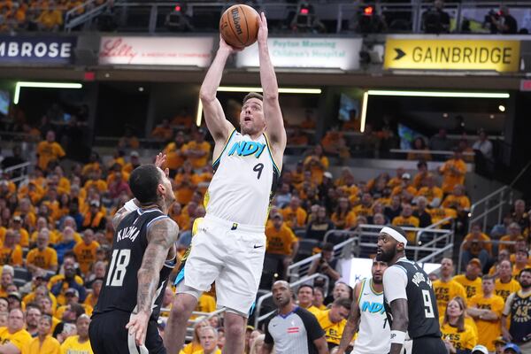 Indiana Pacers guard T.J. McConnell (9) shoots the ball over Milwaukee Bucks forward Kyle Kuzma (18) during the second half in Game 5 of an NBA basketball first-round playoff series in Indianapolis, Tuesday, April 29, 2025. (AP Photo/Michael Conroy)