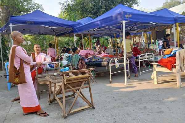Patients receive treatment outdoors in Sagaing General Hospital in Sagaing, Myanmar, Tuesday, April 1, 2025. (Democratic Voice of Burma via AP)