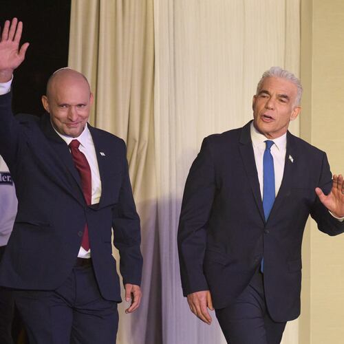 Former Israeli prime ministers Naftali Bennett, left, and Yair Lapid arrive to a joint press conference announcing that their parties will run together in the upcoming elections, in Herzliya, Israel, Sunday, April 26, 2026. (AP Photo/Ariel Schalit)