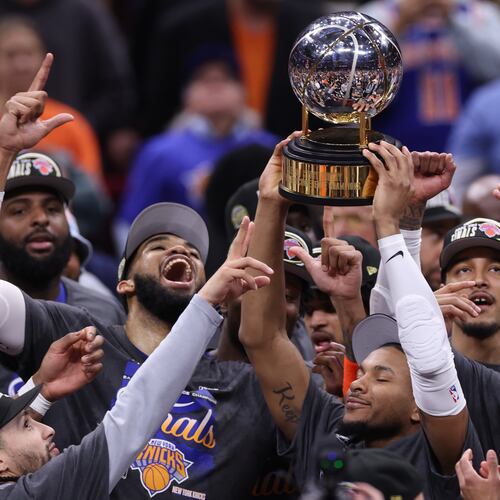 The New York Knicks hold the Eastern Conference Championship trophy after Game 4 in the Eastern Conference finals NBA basketball playoffs series against the Cleveland Cavaliers in Cleveland, Monday, May 25, 2026. (AP Photo/Tim Phillis)