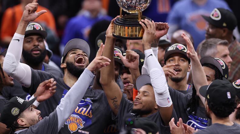 The New York Knicks hold the Eastern Conference Championship trophy after Game 4 in the Eastern Conference finals NBA basketball playoffs series against the Cleveland Cavaliers in Cleveland, Monday, May 25, 2026. (AP Photo/Tim Phillis)
