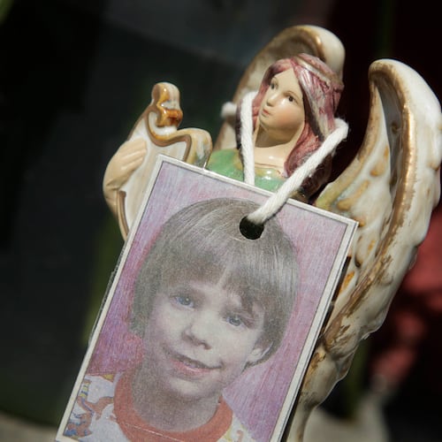 FILE - A photograph of Etan Patz hangs on an angel figurine, as part of a makeshift memorial in New York, May 28, 2012. (AP Photo/Mark Lennihan, File)
