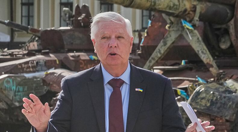 U.S. Sen. Lindsey Graham, R-S.C. answers a question from a media member near damaged Russian vehicles on display in central Kyiv, Ukraine, Friday, July 10, 2026. (AP Photo/Efrem Lukatsky)