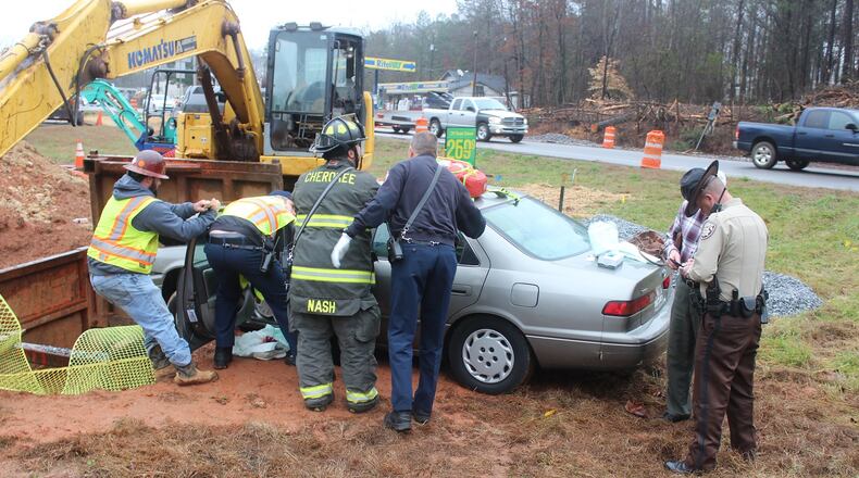 A Cherokee County woman was stuck in her car after hitting the back of a van driven by her husband. (Credit: Cherokee County Fire Rescue)