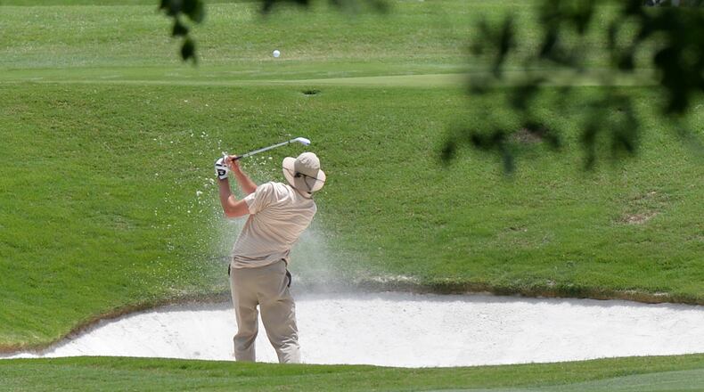 A 2014 AJC file photo shows Gus Wagoner of Duluth, GA hitting from the sand on the 9th hole at Ansley Golf club.