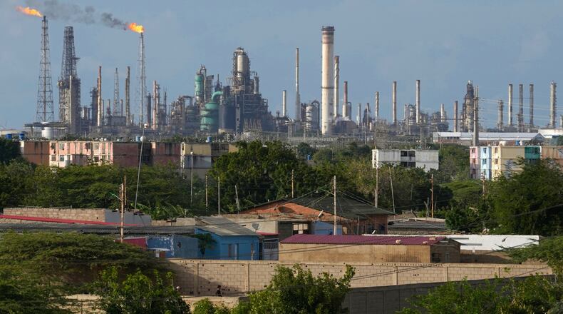 FILE - Flames rise from flare stacks at the Amuay refinery in Los Taques, Venezuela, Jan. 14, 2026. (AP Photo/Matias Delacroix, File)