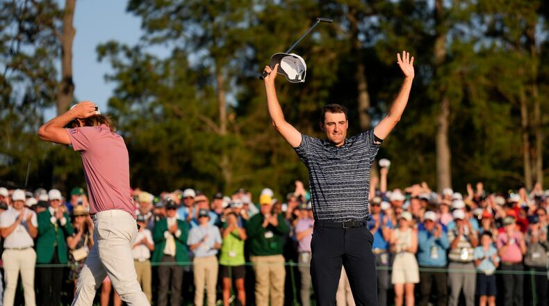 FILE - Cameron Smith, of Australia, walks past as Scottie Scheffler celebrates after winning the 86th Masters golf tournament on April 10, 2022, in Augusta, Ga. (AP Photo/Matt Slocum, File)