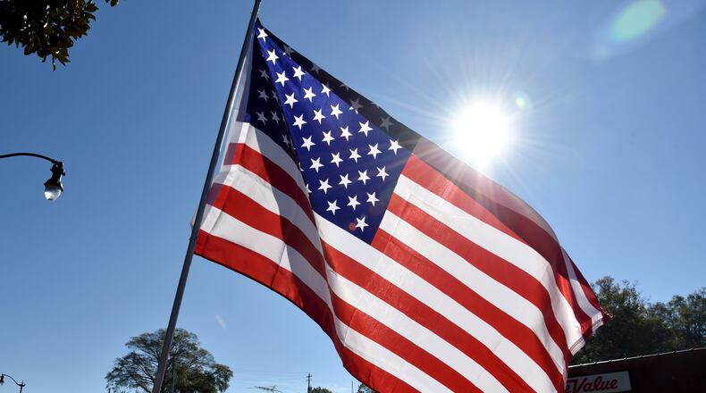 Flags lined the streets of Marietta during the annual Marietta Veterans Day Parade on Nov. 11, 2015. This year’s event will start at 11 a.m. Nov. 11. AJC FILE PHOTO