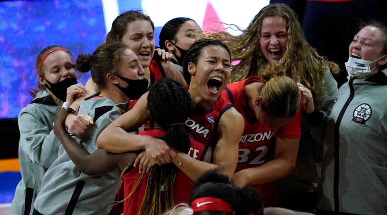 Arizona players celebrate after a women's Final Four NCAA college basketball tournament semifinal game against Connecticut Friday, April 2, 2021, at the Alamodome in San Antonio. Arizona won 69-59. (AP Photo/Eric Gay)