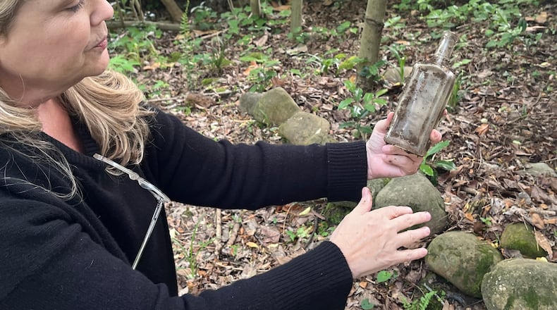 Many objects, like this bottle, have been unearthed in Elizabeth Burns’ lead-contaminated Atlanta yard. (Andy Miller/KFF Health News)